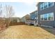 View of the home's backyard featuring a wood fence, patio with pergola, and the home's rear elevation at 1950 Firenza Dr, Apex, NC 27502