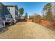 View of the home's backyard with a wood fence, patio, and grill at 1950 Firenza Dr, Apex, NC 27502