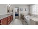 Bright bathroom featuring double vanity, tub, and a separate room at 1950 Firenza Dr, Apex, NC 27502