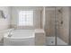 Bathroom featuring a separate tub and tiled shower at 1950 Firenza Dr, Apex, NC 27502