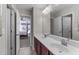 Bathroom featuring double sinks with modern fixtures and a view into the main bedroom at 1950 Firenza Dr, Apex, NC 27502