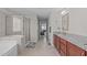 Bright bathroom featuring a double vanity, shower, and tub at 1950 Firenza Dr, Apex, NC 27502