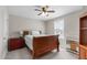 Comfortable bedroom with neutral paint, carpet, and a classic wooden bed at 1950 Firenza Dr, Apex, NC 27502