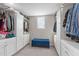 Walk-in closet featuring built-in storage, ample shelving, and carpeted floors at 1950 Firenza Dr, Apex, NC 27502