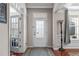 Bright foyer featuring hardwood floors, a glass front door, and an elegant light fixture at 1950 Firenza Dr, Apex, NC 27502