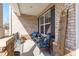 Covered front porch with brick facade, seating and cheerful decor at 1950 Firenza Dr, Apex, NC 27502