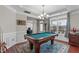 Spacious game room with a pool table, hardwood floors, and large windows at 1950 Firenza Dr, Apex, NC 27502