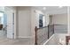 Upstairs hallway with decorative railing, leading to various rooms in the home at 1950 Firenza Dr, Apex, NC 27502