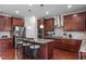 Modern kitchen featuring stainless appliances, center island and wood floors at 1950 Firenza Dr, Apex, NC 27502