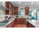 Updated kitchen features dark wood cabinets and modern stainless steel appliances at 1950 Firenza Dr, Apex, NC 27502