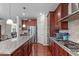 Spacious kitchen featuring stainless appliances, granite counters, and hardwood flooring at 1950 Firenza Dr, Apex, NC 27502