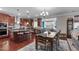 Eat-in kitchen features wood floors, island with seating, and stainless appliances at 1950 Firenza Dr, Apex, NC 27502