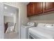 Dedicated laundry area with modern machines, storage, and views of the stairwell at 1950 Firenza Dr, Apex, NC 27502