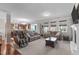 Open-concept living room with plush seating, hardwood floors, and natural light at 1950 Firenza Dr, Apex, NC 27502