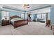 Spacious main bedroom featuring a large bed, sitting area, and ample natural light at 1950 Firenza Dr, Apex, NC 27502