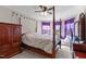 Main bedroom featuring a canopy bed, natural light and a ceiling fan at 1950 Firenza Dr, Apex, NC 27502