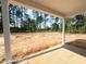 Covered back porch overlooking large backyard with many trees at 205 Regis Ln # 11, Coats, NC 27521