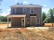 Rear exterior view featuring a covered patio and windows at 205 Regis Ln # 11, Coats, NC 27521