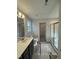 Well-lit bathroom featuring a vanity with modern fixtures, toilet, and shower with glass door at 205 Regis Ln # 11, Coats, NC 27521