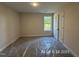 Bright, empty bedroom with a window view of lush greenery at 205 Regis Ln # 11, Coats, NC 27521