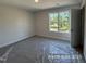 Bedroom with new carpet and bright natural light from the exterior at 205 Regis Ln # 11, Coats, NC 27521