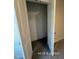 A view of the closet featuring an upper shelf and metal hanging rod at 205 Regis Ln # 11, Coats, NC 27521
