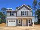 Charming two-story home with gray siding, black shutters, and a covered front porch at 205 Regis Ln # 11, Coats, NC 27521