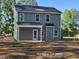 Exterior angle view of gray two-story home with covered porch at 205 Regis Ln # 11, Coats, NC 27521