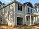 Two-story home with gray siding and an attached, open garage providing ample space for vehicles and storage at 205 Regis Ln # 11, Coats, NC 27521