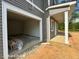 Attached garage with ample space, accessible from the house and an open outdoor patio with white columns at 205 Regis Ln # 11, Coats, NC 27521