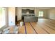 Kitchen featuring an island and stainless steel appliances with gray cabinets and stone countertops at 205 Regis Ln # 11, Coats, NC 27521