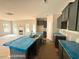 Spacious kitchen featuring dark cabinets, a large island with sink, and natural light at 205 Regis Ln # 11, Coats, NC 27521