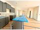 The kitchen features gray cabinets and stone countertops with a sink in the island at 205 Regis Ln # 11, Coats, NC 27521