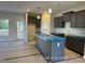 Open kitchen with gray cabinets, stainless steel sink in the island, and lots of light at 205 Regis Ln # 11, Coats, NC 27521