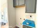 Laundry room includes washer/dryer hookups and overhead cabinets at 205 Regis Ln # 11, Coats, NC 27521