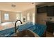 An open-concept living space connecting to a kitchen with gray cabinets and stone countertops at 205 Regis Ln # 11, Coats, NC 27521