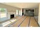 An open living space with large windows and a fireplace that connects to the kitchen at 205 Regis Ln # 11, Coats, NC 27521