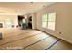 Open-concept living area with views to the kitchen featuring large windows and a fireplace at 205 Regis Ln # 11, Coats, NC 27521