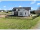 Expansive backyard with black metal fencing surrounding a two-story farmhouse on a sunny day at 2142 Henderson Tanyard Rd, Pittsboro, NC 27312