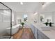 Bright bathroom featuring double vanities, soaking tub, and modern fixtures at 2142 Henderson Tanyard Rd, Pittsboro, NC 27312