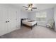 This bright bedroom offers a ceiling fan and a comfortable sleeping space at 2142 Henderson Tanyard Rd, Pittsboro, NC 27312