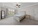 Spacious primary bedroom with neutral tones, plush carpet, and lots of natural light at 2142 Henderson Tanyard Rd, Pittsboro, NC 27312