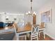 Charming dining room with wood table, stylish chairs, and a view into the spacious living area at 2142 Henderson Tanyard Rd, Pittsboro, NC 27312