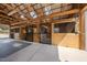 Well-lit horse stall featuring wood construction, metal gates, and rubber flooring for a comfortable environment at 2142 Henderson Tanyard Rd, Pittsboro, NC 27312
