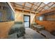 Hay-filled horse stall with wood paneling and a black metal barred window allowing for light and ventilation at 2142 Henderson Tanyard Rd, Pittsboro, NC 27312