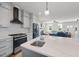 Modern kitchen with stainless steel appliances, white countertops, and sleek gray cabinets at 2142 Henderson Tanyard Rd, Pittsboro, NC 27312