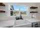 Farmhouse sink with a view to the fields beyond, accompanied by modern fixtures and open shelving at 2142 Henderson Tanyard Rd, Pittsboro, NC 27312