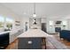 Open-concept kitchen featuring a large island, stainless steel appliances, and views of the living room at 2142 Henderson Tanyard Rd, Pittsboro, NC 27312