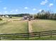 This farm features a barn, multiple horses, and green pastures at 2142 Henderson Tanyard Rd, Pittsboro, NC 27312