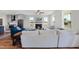 Bright living room featuring a fireplace, large windows, and open access to the modern kitchen at 2142 Henderson Tanyard Rd, Pittsboro, NC 27312